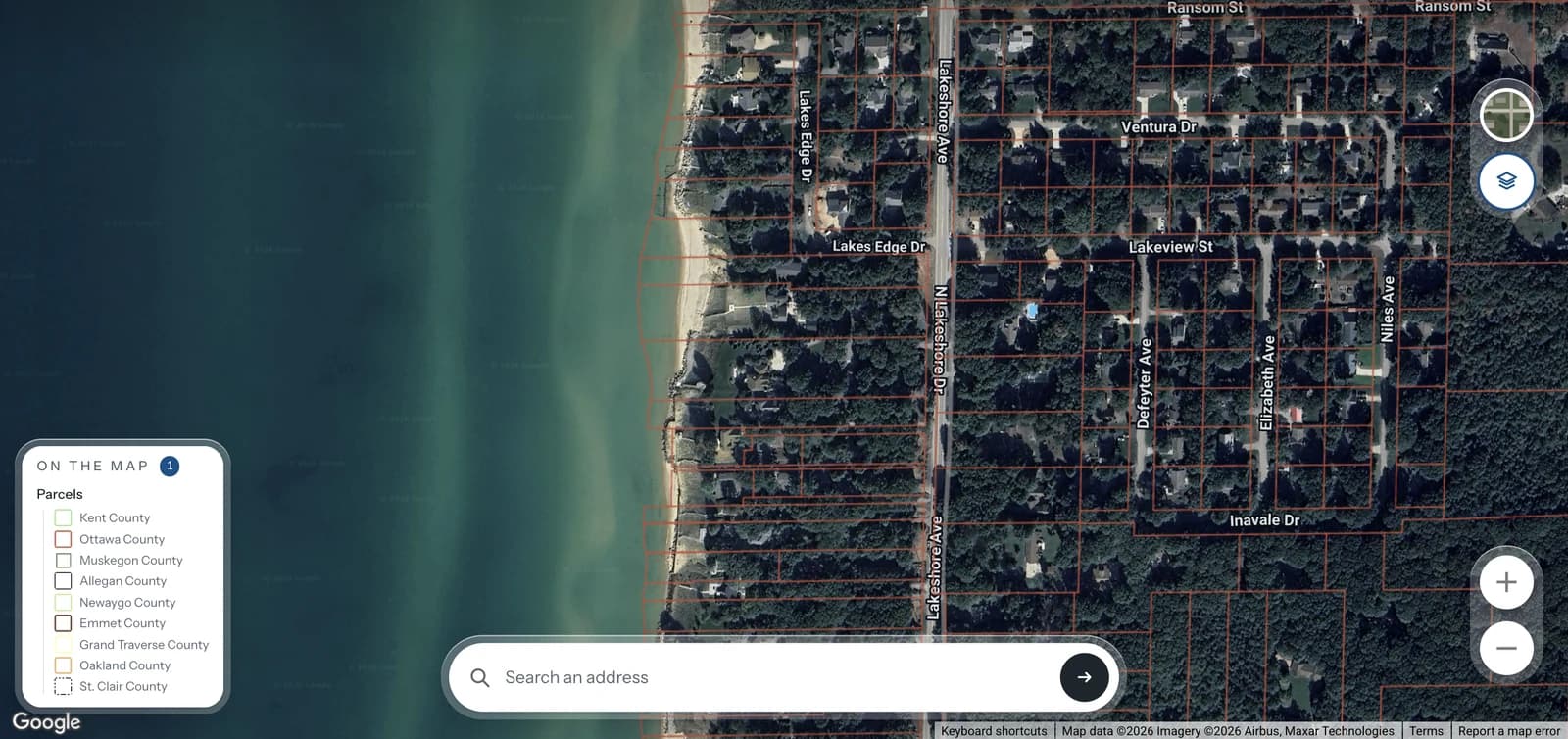 Parcel boundaries drawn over aerial imagery of the Lake Michigan shoreline north of Holland, every lot outlined in red with the street names over the top.
